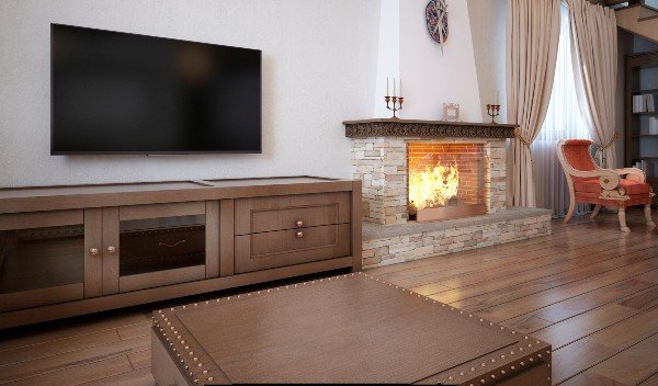 A cozy sitting area made of dark wood furniture placed in front of a blazing fireplace