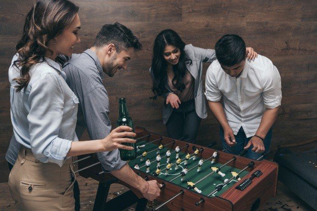 Young people play table football - set up a party cellar